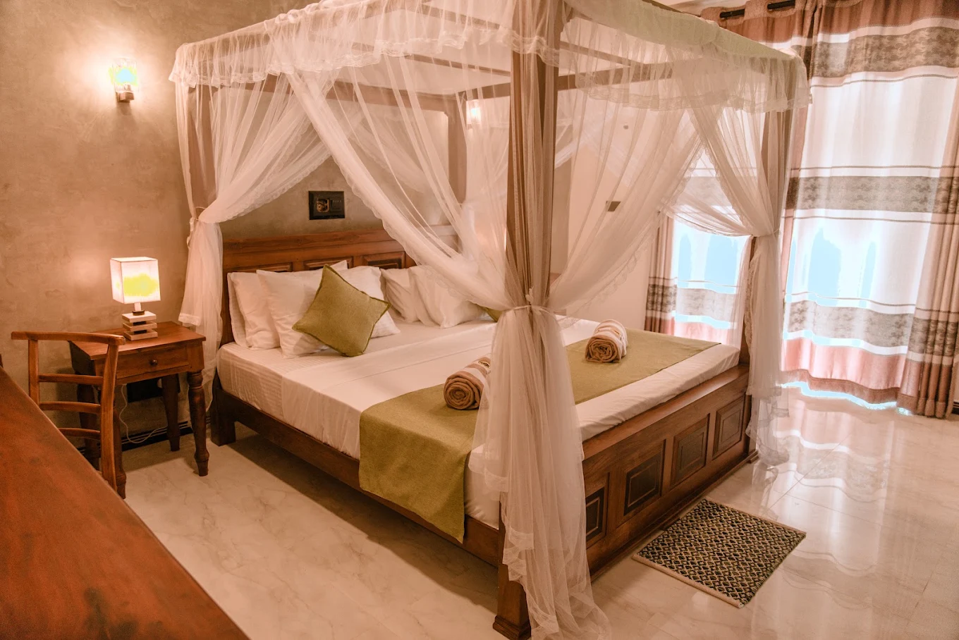 Bright guest bedroom with a canopy bed and wooden furnishings at Monkey Island Villa