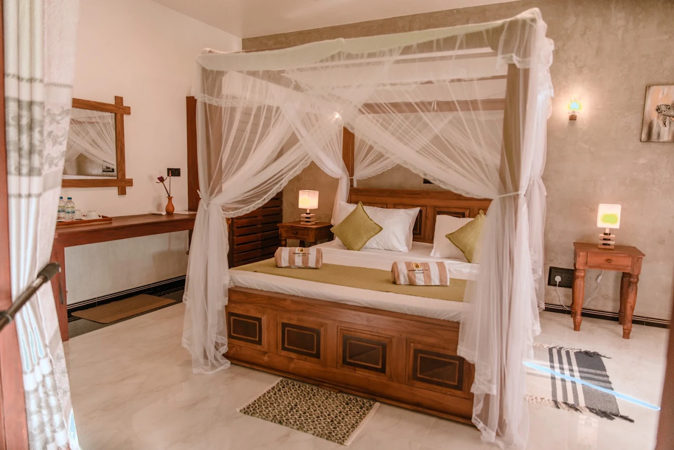 Guest bedroom with a wooden canopy bed and soft green bedding