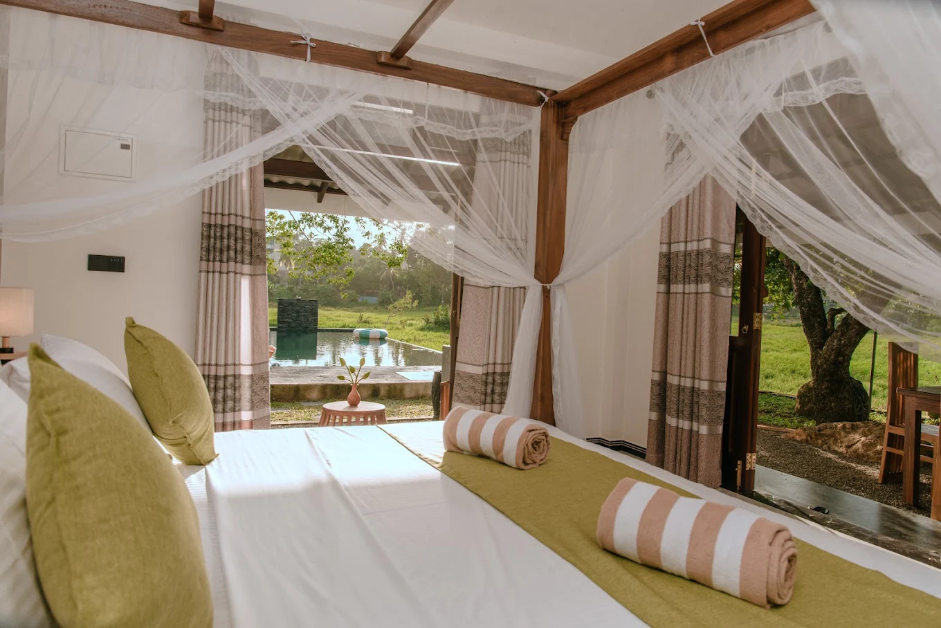 Guest bedroom opening onto the pool and garden at Monkey Island Villa