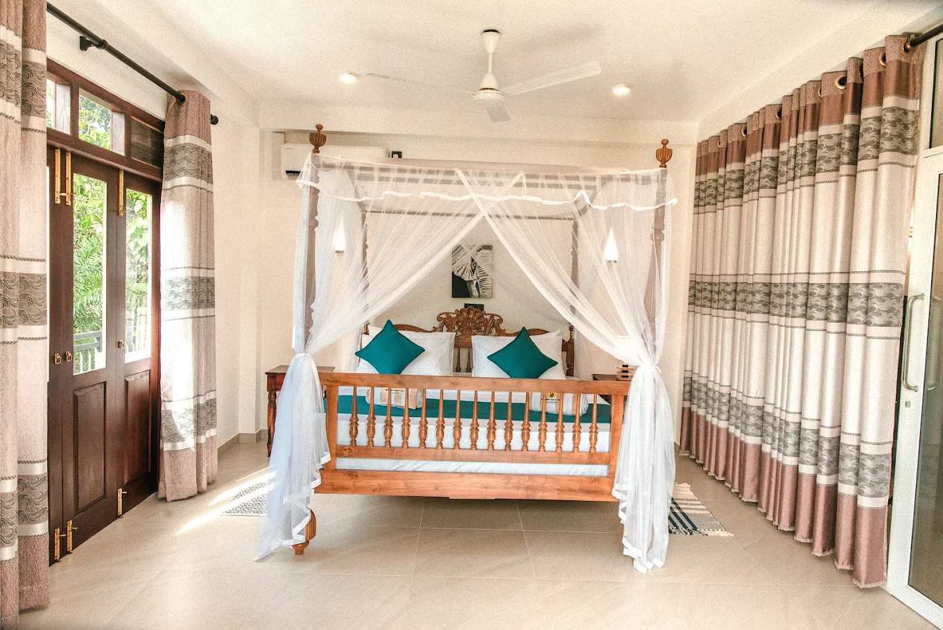 Spacious guest bedroom with a wooden canopy bed at Monkey Island Villa