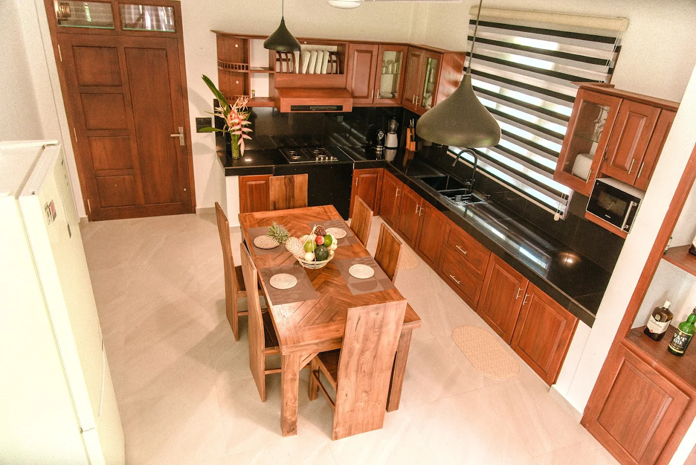 Wooden kitchen and dining area at Monkey Island Villa